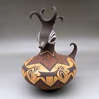 A polychrome duck pot decorated around the body with a deer with heart line and geometric design
 by Anderson Peynetsa of Zuni