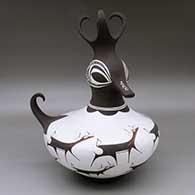 A polychrome duck pot decorated around the body with a deer with heart line and geometric design
 by Anderson Peynetsa of Zuni