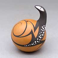A polychrome seed pot decorated with a lizard head applique and lizard and geometric design
 by Anderson Peynetsa of Zuni