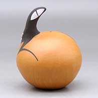 A polychrome seed pot decorated with a lizard head applique and lizard and geometric design, click or tap to see a larger version