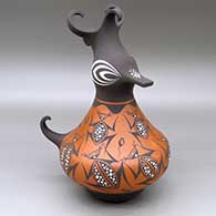 A polychrome duck pot with a feathered crest and decorated with a frog, tadpole and geometric design
 by Anderson Jamie Peynetsa of Zuni