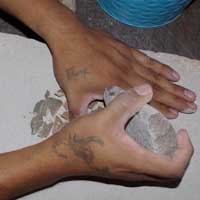 Breaking up the pottery shards