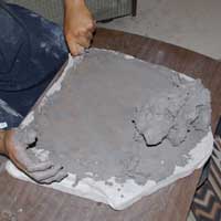 The mix is scraped up with a wooden scraper