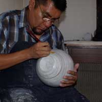 Painting orange slip with a yucca brush