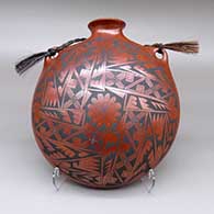 Polychrome canteen with a flared opening, a geometric design, and a braided horsehair rope